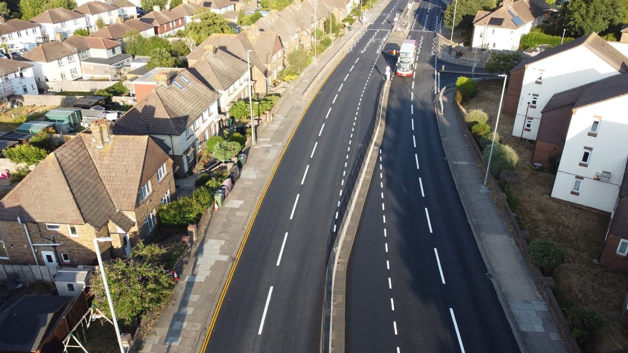 Aerial view of a newly resurfaced road in Brighton and Hove with a bus travelling along it