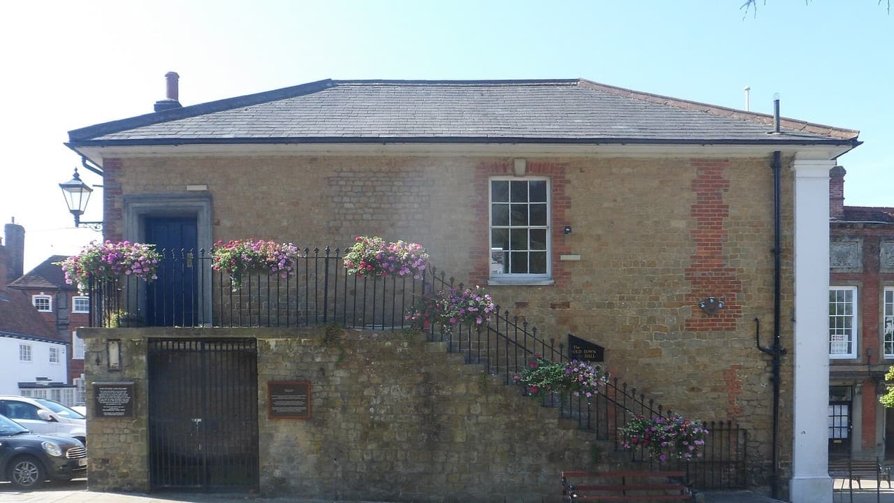 The brick Old Town Hall in Market Square, Midhurst, with flower baskets along its outside staircase