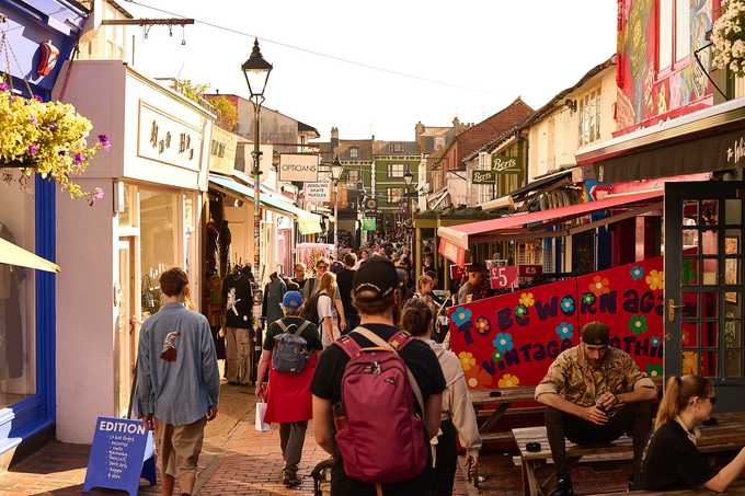 Shoppers walking along a busy independent shopping street in central Brighton on a September afternoon