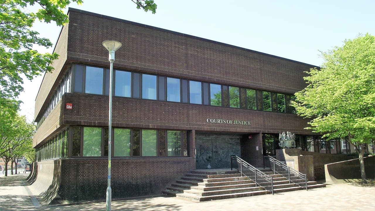 The brown brick front of Portsmouth Crown Court, with steps leading up to its main doors