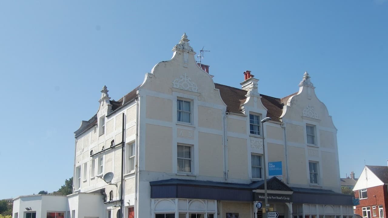 The cream-coloured Co-op store building on Fort Road, Newhaven, under a clear blue sky
