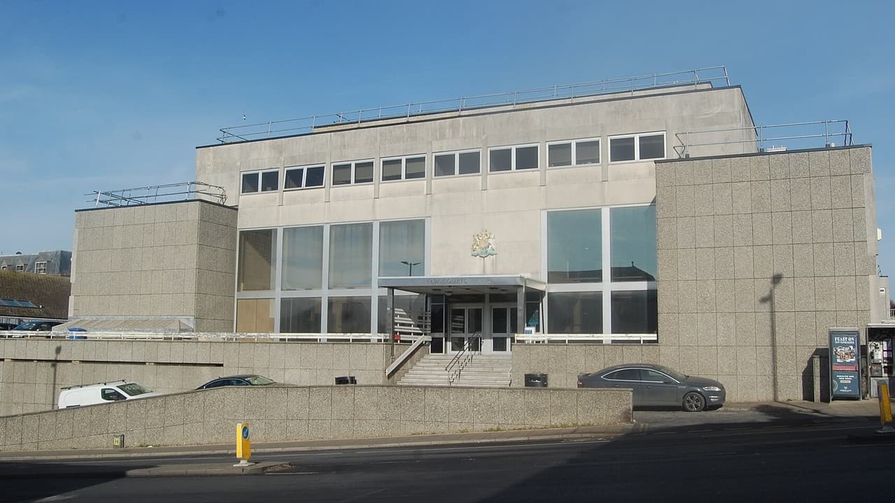 The grey concrete and glass front of Brighton Law Courts on Edward Street under a blue sky