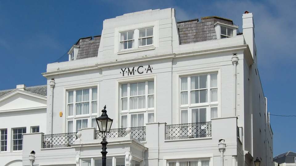 Steine House on the Old Steine in Brighton, a white Regency building with the letters YMCA above the first-floor windows, seen from the corner