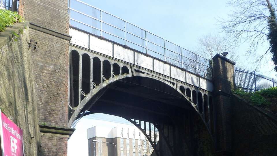 The Grade II listed cast iron railway bridge over New England Road in Brighton, with its curved arch ribs and railings