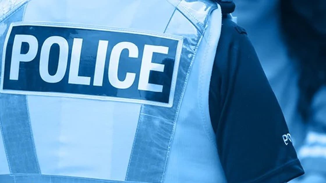 Police officer in a high-visibility vest marked POLICE, in a Sussex Police image used for its advice alert about burglaries in Brighton, Portslade and Shoreham
