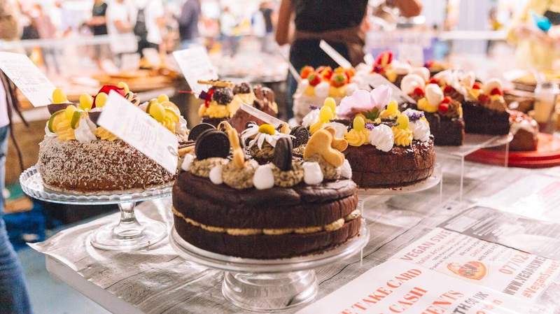Vegan cakes and desserts on display on a table at an earlier VegfestUK show